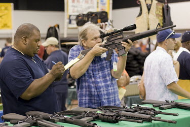 Potential owners browse at a gun show in West Palm Beach, Florida which sells all types of guns. Florida has some of the most permissive gun ownership laws in the USA.