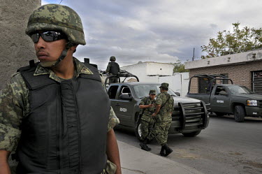 Military police protect a crime scene where a murder had taken place. Ciudad Juarez is the most violent city in Mexico, and the epicentre of the war on drugs. In 2008, 2,000 people were murdered, an a...