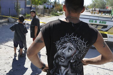 Bystanders and onlookers at a murder scene. Ciudad Juarez is the most violent city in Mexico, and the epicentre of the war on drugs. In 2008, 2,000 people were murdered, an average of 5.5 murders a da...