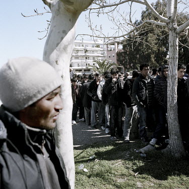 Afghan refugees queue to get food being given out by a local religious organisation. Patras is home to about 3,000 illegal immigrants. Most of them are Afghans, although there are also some Iranians a...