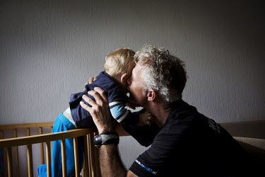 Wilco van Rooijen kisses his child at home in Utrecht. Wilco was one of only a handful of mountaineers who managed to survive an avalanche on K2 in July 2008.