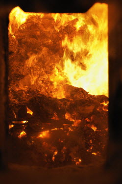 Garbage is burnt in a furnace at Covanta Waste-to-Energy plant, Westbury, New York. The plant feeds rubbish into giant furnaces that produce steam to turn a turbine and produce electricity.