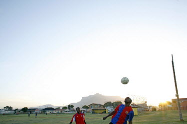 Richard Nifasha heads a ball during football practise at a community field in Kensington, Cape Town. Richard, a refugee from Burundi, was a professional footballer and played for the Burundi national...