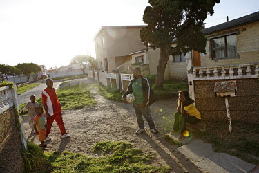 Richard Nifasha (left) outside his house with his two sons, his friend Saliem Bakari and wife Mwadjuma in Kensington, Cape Town. Richard, a refugee from Burundi, was a professional footballer and play...