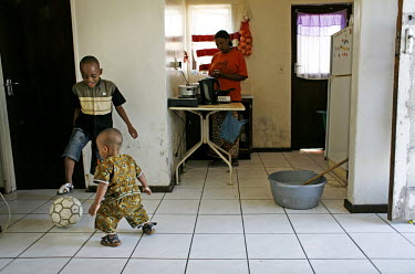 Bashir and Nashir Nifasha play with a ball in the lounge of the home that the family share with another immigrant family in Kensington, Cape Town. Their father Richard Nifasha was a professional footb...