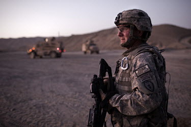 US Army Sergeant Major Wolfe from 1st Battalion, 501st Infantry Airborne patrols at dusk at Mest Malak, an Afghan National Police (ANP) outpost in Paktika Province.