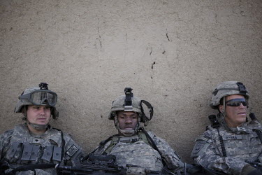 US Army soldiers from 501st Airborne Scout unit rest after clearing buildings in a compound suspected of housing Taj Mohammed, a Taliban facilitator, during an air assault operation in Paktika Provinc...