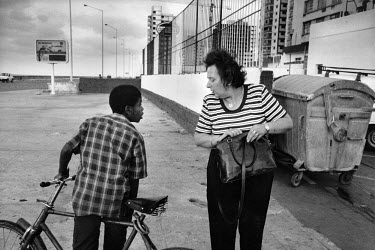 A tourist being approached for money along the Malecon.