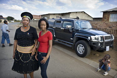 Businesswoman Melinda Delange (left) next to her Hummer during a visit to Soweto, where she was born and raised. She now lives in a villa outside Johannesburg.