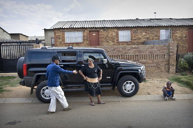 Businesswoman Melinda Delange next to her Hummer during a visit to Soweto, where she was born and raised. She now lives in a villa outside Johannesburg.