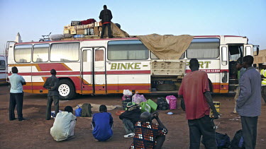 Migrants wait at the bus station in Bamako.