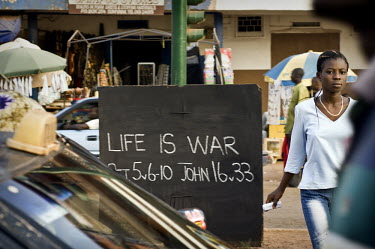 An artist's interpretation of a biblical passage written on a blackboard on a street in Berekum. Everyday, a local artist writes something on this passage which often reflects the desperation of the l...
