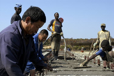 Chinese contractors and Angolan labourers rebuilding bridges along the Luena - Lucusse road. Infrastructure in large parts of the country was destroyed during the long years of war. As thousands of la...