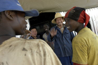 Chinese contractors and Angolan labourers rebuilding bridges along the Luena - Lucusse road. Infrastructure in large parts of the country was destroyed during the long years of war. As thousands of la...