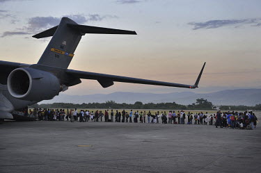 Haitians with American passports wait to be evacuated from the airport of Port-au-Prince by a US Air Force C-17 to the United States five days after an earthquake hit the city.A 7.0 magnitude earthqua...
