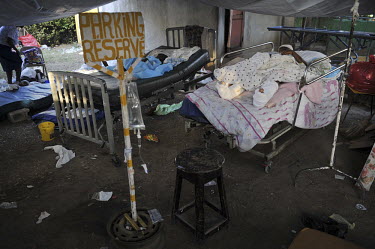 An injured boy resting in a bed at the hospital five days after an earthquake hit Port-au-Prince. Due to the high number of patients, many are housed in the gardens and the parking lot. A 7.0 magnitud...