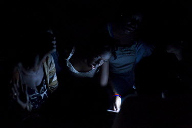 Mothers and daughters sing hymns at night in a small clinic in Port-au-Prince, six days after an earthquake hit the country. A 7.0 magnitude earthquake struck Haiti on 12/01/2010. Early reports indica...