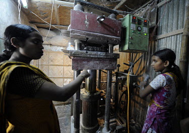 12 year old Shaida operates heavy machinery at a factory where cutlery and bowls are made from melamine powder, a substance believed to be carcinogenic. She is supervised by 30 year old Lipi.