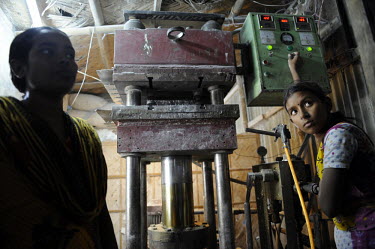 12 year old Shaida operates heavy machinery at a factory where cutlery and bowls are made from melamine powder, a substance believed to be carcinogenic. She is supervised by 30 year old Lipi.