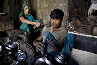 14 year old Jashim works at a factory, which employs many children, producing metal lunch boxes.
