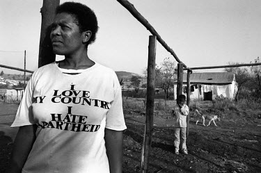 A woman and her child stand outside their home in the dying days of the apartheid era.