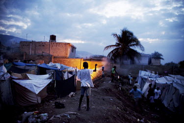 People displaced by the earthquake living in a camp on open ground. A boy is playing.A 7.0 magnitude earthquake struck Haiti on 12/01/2010. Early reports indicated that more than 100,000 may have been...