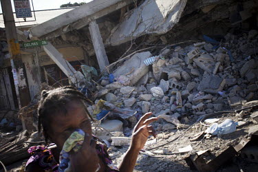 A woman walks through an area devastated by an earthquake twelve days earlier. The stench of decomposing bodies was very strong. A 7.0 magnitude earthquake struck Haiti on 12/01/2010. Early reports in...