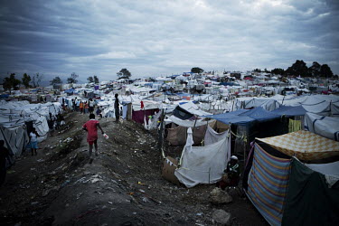 People displaced by the earthquake living in a camp on open ground.A 7.0 magnitude earthquake struck Haiti on 12/01/2010. Early reports indicated that more than 100,000 may have been killed and three...