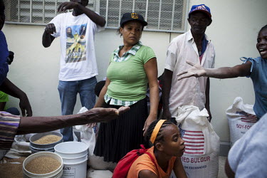 Distribution of food aid, including sacks of wheat from the USA, in a church eleven days after an earthquake hit the country. A 7.0 magnitude earthquake struck Haiti on 12/01/2010. Early reports indic...