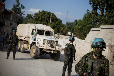 A truck distributing aid supplied by the NGO Handicap International is escorted by UN Minustah soldiers. A 7.0 magnitude earthquake struck Haiti on 12/01/2010. Early reports indicated that more than 1...