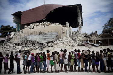 People queueing for distribution of food aid by the United Nations World Food Programme (UN WFP) in front of a building devastated by the earthquake.A 7.0 magnitude earthquake struck Haiti on 12/01/20...