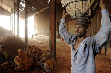 A labourer carries bricks rejected by the factory to be broken up into ballast for manufacturing concrete. Many children are employed in this work, earning between 25-50 Euro cents a day.