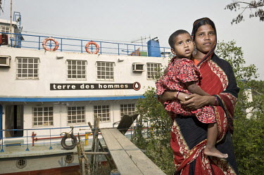 A mother and child leave the Shapla hospital; a floating clinic for island residents in the delta region of southern Bangladesh. It is run by the Dutch NGO Terre des Hommes. On board there is a basic...