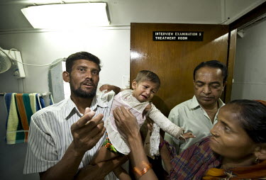 A young girl with a broken arm is treated at the Shapla hospital; a floating clinic for island residents in the delta region of southern Bangladesh. It is run by the Dutch NGO Terre des Hommes. On boa...