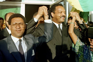 African National Congress (ANC) leader Allan Boesak greets Reverend Jesse Jackson at Cape Town's airport the day before the announcement of Nelson Mandela's release from prison.