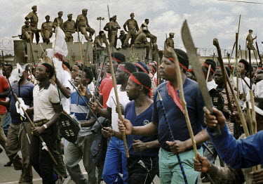 Police watch an Inkatha Freedom Party (IFP) march to a rally in Soweto.