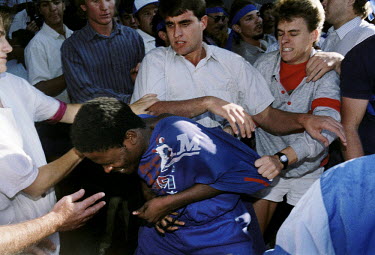 White students attack an African National Congress (ANC) supporter in Pretoria in the dying days of the apartheid era.