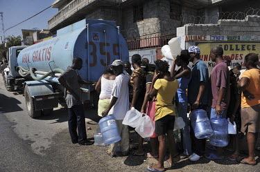 People line up for free water rations handed out by the government after an earthquake hit the country.A 7.0 magnitude earthquake struck Haiti on 12/01/2010. Early reports indicated that more than 100...