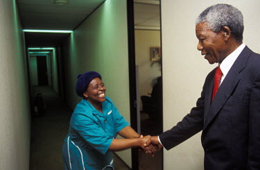 Nelson Mandela greeting a staff member at his office shortly after he became President.