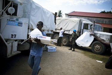 Trucks from the NGO Handicap International delivering aid in the form of hygiene kits supplied by USAID fifteen days after an earthquake hit the country. UN soldiers provide security.A 7.0 magnitude e...