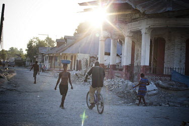 A man on a bicycle in the village of Leogane, near the epicentre of the earthquake that struck fifteen days earlier. A 7.0 magnitude earthquake struck Haiti on 12/01/2010. Early reports indicated that...