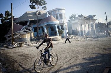 A man on a bicycle in the village of Leogane, near the epicentre of the earthquake that struck fifteen days earlier. A 7.0 magnitude earthquake struck Haiti on 12/01/2010. Early reports indicated that...