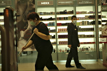 Sales personnel wear face masks in an upmarket cosmetics store in the Arena building.
