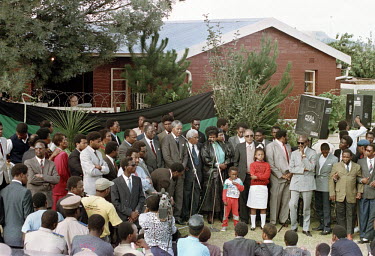 Nelson Mandela, flanked by Walter Sisulu, Winnie Mandela and other members of the African National Congress (ANC), speaks to a crowd outside his Soweto home after his release from prison.