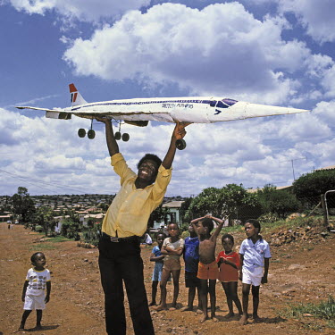Metal artist Titus Moteyane holds up his piece based on a British Airways Concorde plane in the Atteridgeville township.