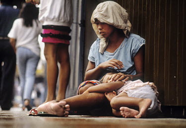 Mother and child begging in the street.