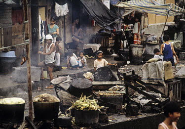 Cooking maize in a slum area in Manila.