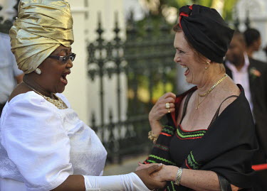 MPs from the ruling African National Congress (ANC) party, Vatiswa Bam-Mugwanya (left) and Gloria Borman greet each other on arrival at Parliament for the opening of the 2010 session. The occasion was...