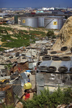 A shanty town on the outskirts of Luanda overlooks a Sonangol (the Angolan state oil company) complex. Angola is nowAfrica's second largest oil-producing nation.
