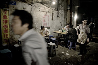 People gather for drinks and food in an old neighbourhood of the city. Chongqing is now the largest municipality in the world, with a population of 31 million residents.